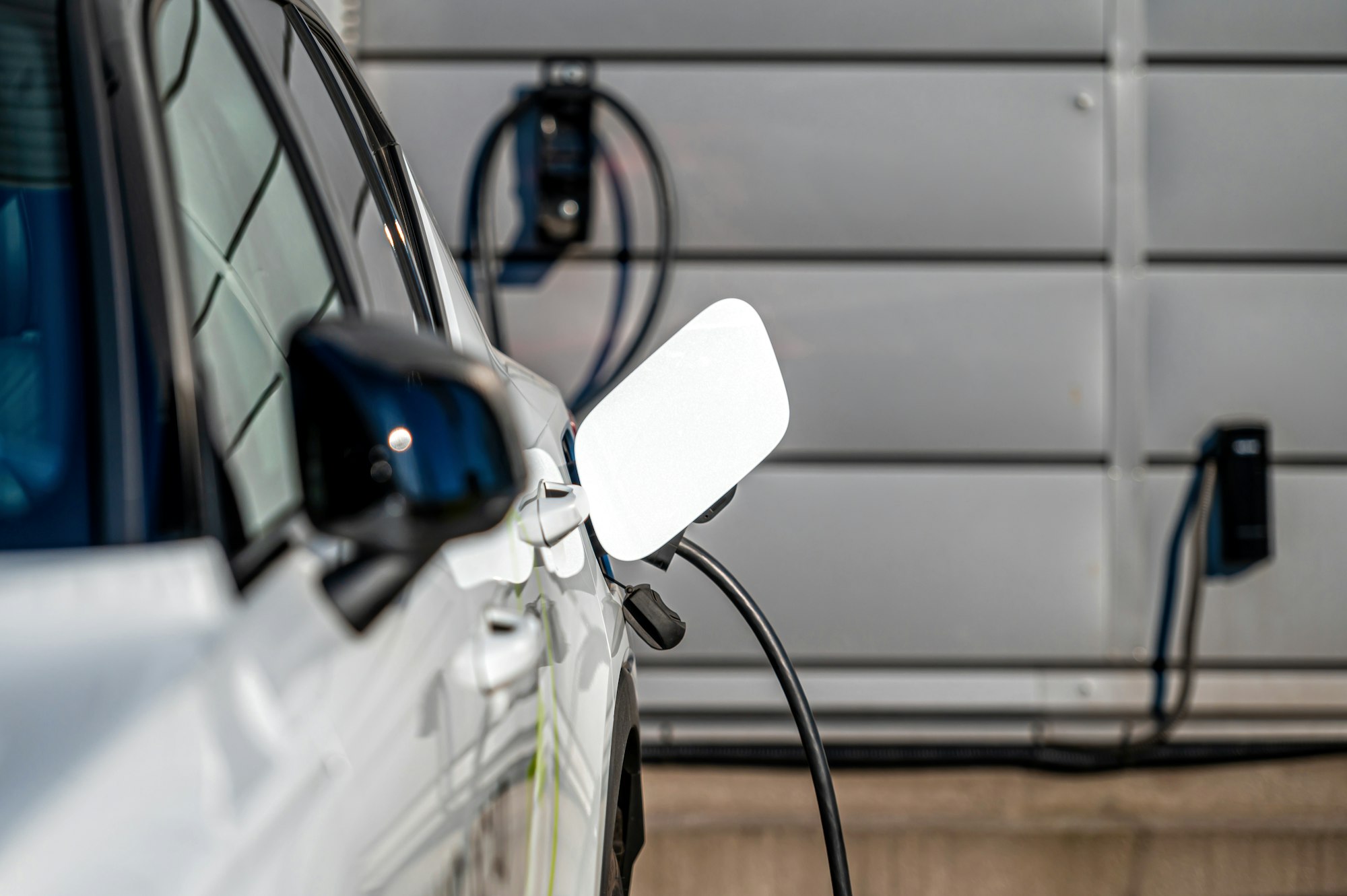 The electric car charger plugged in to the socket.The modern electric car charging the battery